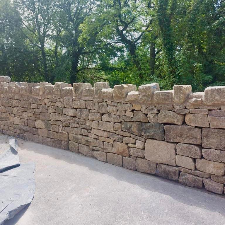 Reclaimed Dry Stone Walling Stone used in garden design to create boundaries and traditional stone walls - Britannia Stone