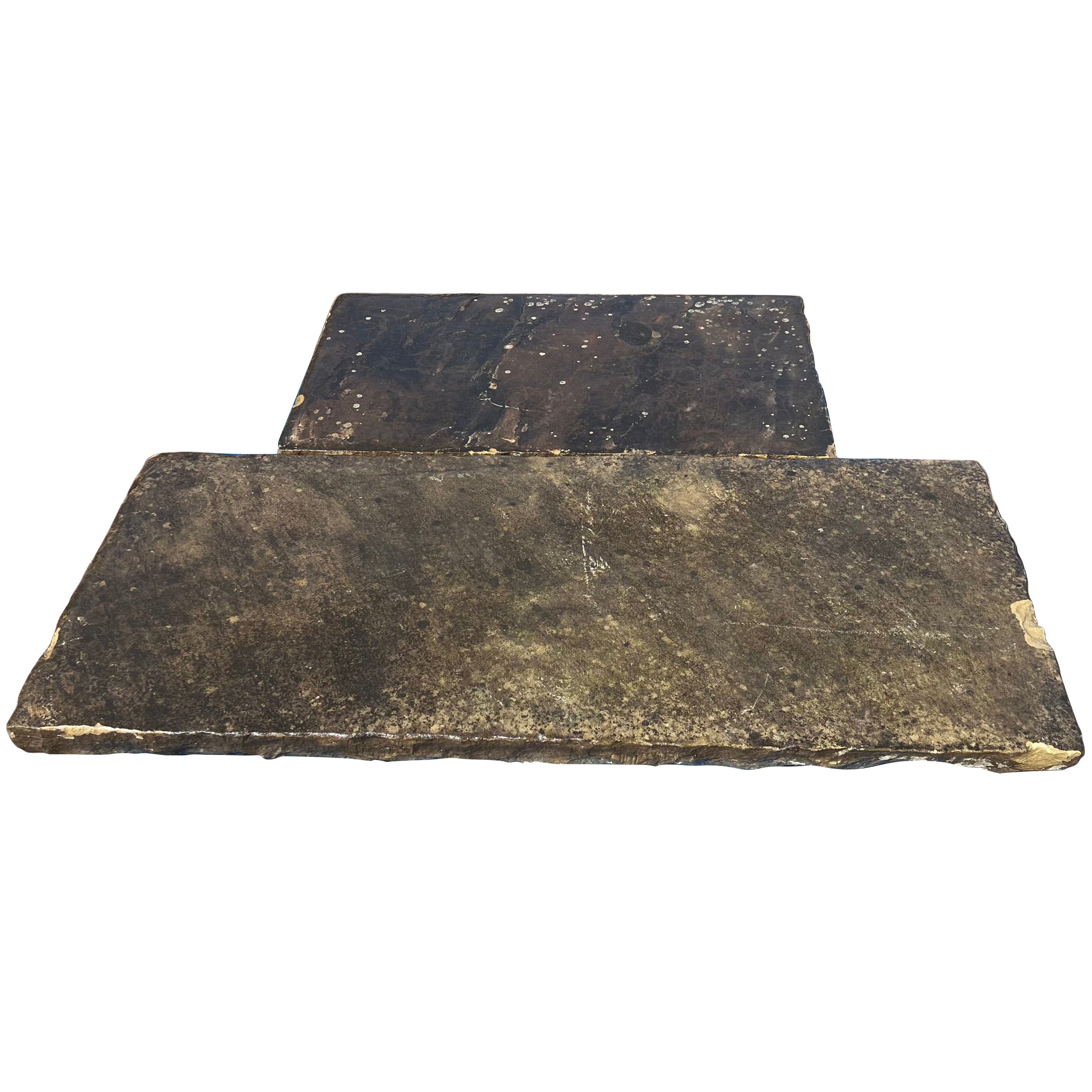 Two dark brown stone slabs on a white background