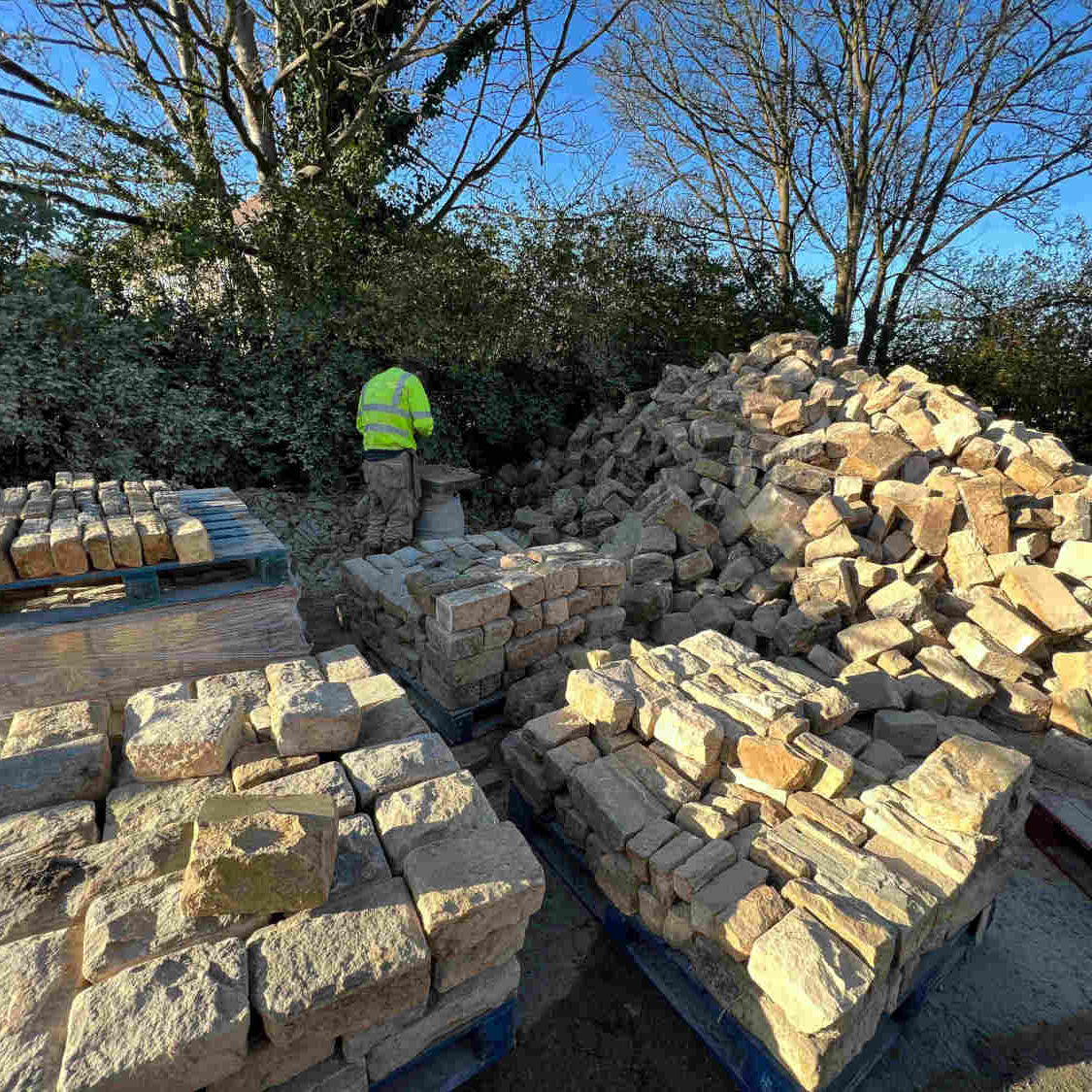 Stone mason dressing reclaimed delph stone from old pub demolition in Sheffield | Britannia Stone
