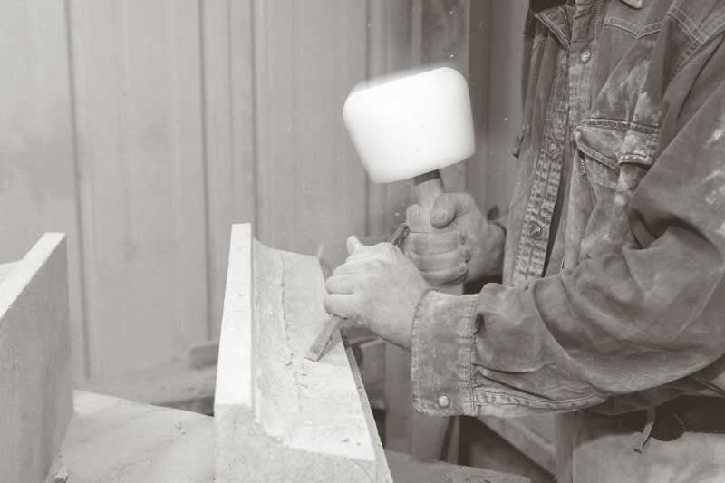 stone mason working limestone by hand